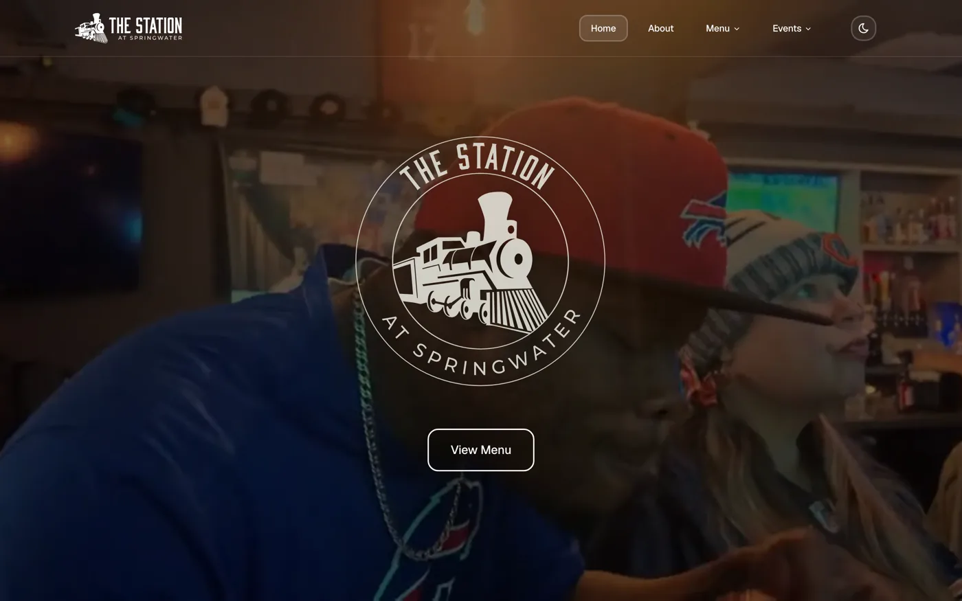 The Station at Springwater restaurant website, a warm hospitality site with a circular train logo over a photo of guests